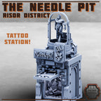 Tattoo station model with 'The Needle Pit' branding on a gray background